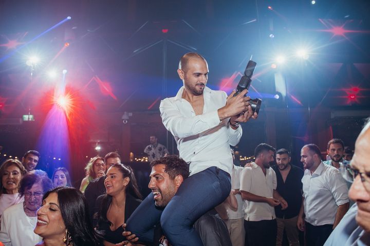 אורח על הכתפיים ברחבה עם מצלמה ביד